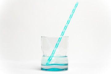 glass of water with drinking straw isolated on white