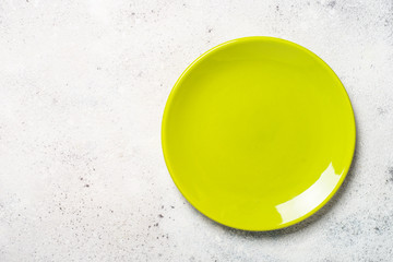 Green plate on light stone table.