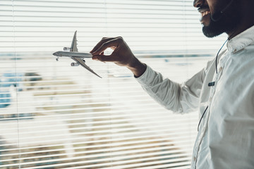 Close up of airplane model in hand of dispatcher