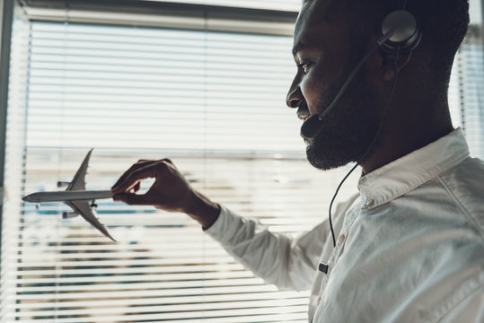 Close up afro-american man with airplane model