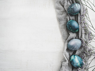 Easter eggs painted in bright colors on a white background. Top view, close-up, isolated. Happy Easter. Preparation for the holiday