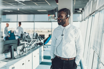 Waist up of operator man working via headset
