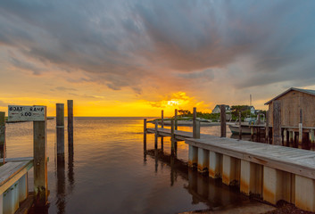 Obraz premium Sunset over fishing harbor 