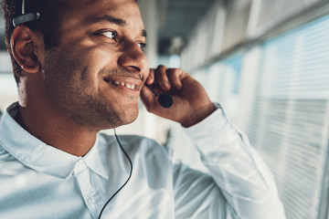 Close up of smiling operator man with headset