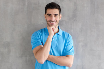 Young handsome european caucasian man isolated on gray background standing with arms crossed and...