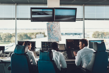 Group of air dispatchers talking in navigation room