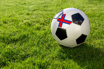 Fototapeta premium Football on a grass pitch with Faroe Islands
