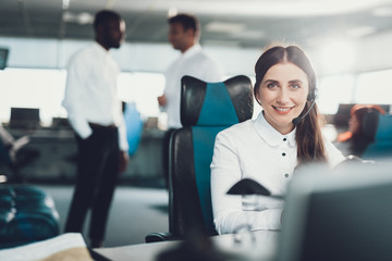 Smiling female dispatcher sitting on operator place