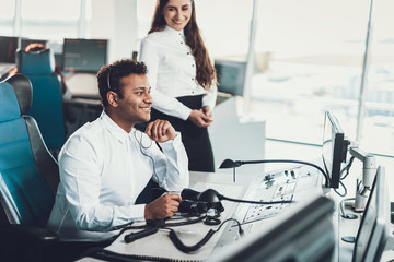 Smiling male dispatcher sitting on work place