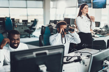 Male dispatcher looking at binocular far away