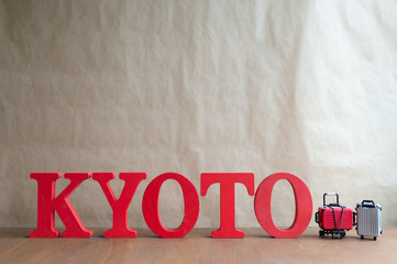Kyoto text and Miniature  suitcase on wooden background,  travel concept. minimal style ,Panoramic banner background with copy space
