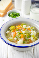 Vegetable soup with cauliflower, Brussels sprouts, white cabbage, carrots and green peas. Delicious healthy lunch, spring food