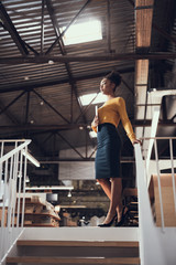 Gorgeous afro american businesswoman standing at the top of stairs