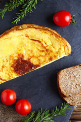 Healthy breakfast - rustic omelette with whole wheat bread and fresh tomato cherry