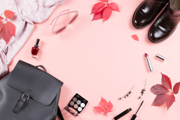 Autumn female clothes collection. Women fall fashion concept flat lay. Backpack, boots, scarf and cosmetics overhead