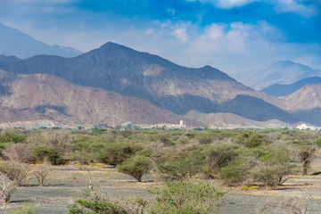 Scenic shot of the rocky desert of the northern United Arab Emirates near Oman with shadows on the mountains.