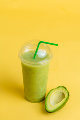 exotic green smoothie contains vitamins and minerals, isolated yellow background. food, breakfast concept