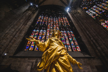 Milan, Italy - AUGUSTA 18, 2018: Interior of Milan Cathedral Duomo. Statue of golden Madonna