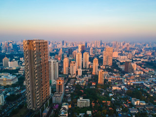 Fototapeta na wymiar Aerial view of Bangkok modern office city building colorful sunrise