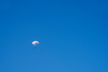 Lonely skydiver in blue sky