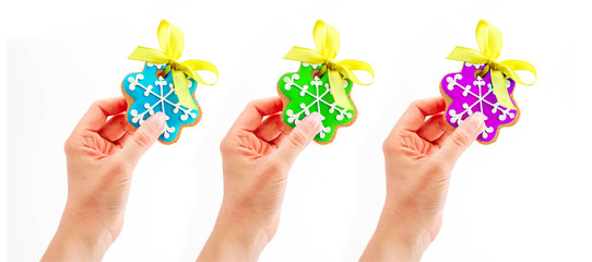 Female hands holding homemade gingerbread Christmas cookies, isolated on white. New Year holiday decoration, winter time food.