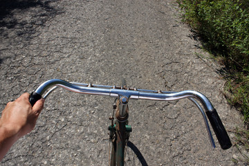 Fototapeta na wymiar Point of View: Riding an old bicycle