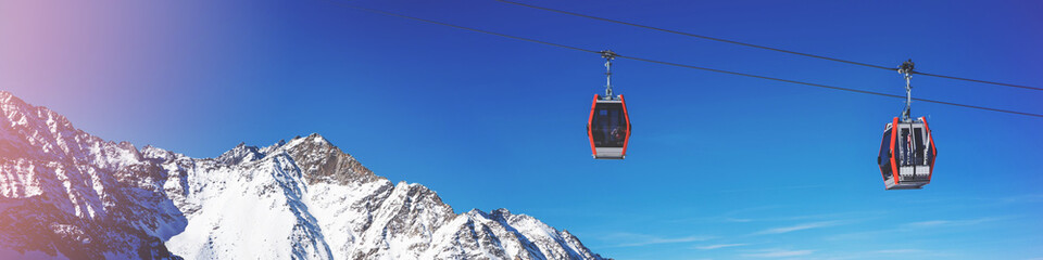 ski cable cars over mountain landscape on sunny winter day