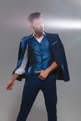 portrait of gentleman wearing a blue suit on shoulder