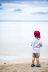 Asian boy walking the tropical beach, Happy little boy walking near the sea