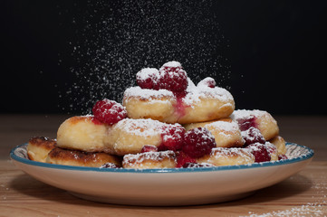 Cheesecake with raspberries, grenades sprinkle with powdered sugar cheese cakes. food background