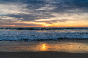 Fototapeta na wymiar View of sea and waves at sunset