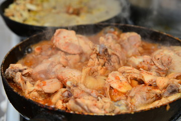 Fried chicken with spices in a pan