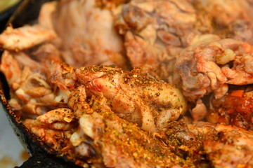 Fried chicken with spices in a pan