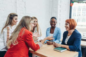 Young mixed race women team up with freelance friends and create a small coworking club that can eventually grow into a small firm.