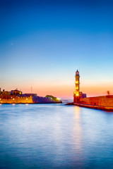 Fototapeta na wymiar Old Venetian Port in Chania and Ancient Lighthouse on Pier.