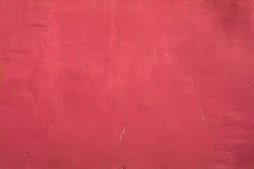 Red painted wall with scratches