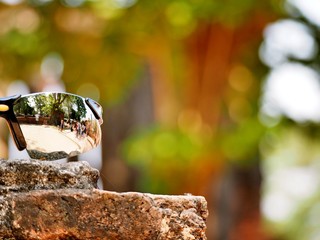 The reflection on a traveller's sunglasses at The Wat Mahathat, Ayutthaya, Thailand. This place also be one of ayutthaya historical park.
