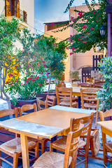 Sunny Open Air Cafe in Chania City on Crete. With Flowers and Olive Trees All Round in Crete, Greece.