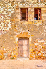 Textured Stony Walls of Colorful Houses in Chania on Crete, Greece.