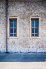 Two Symmetrical Windows and Gutter on the Wall of Shipyard in Chania