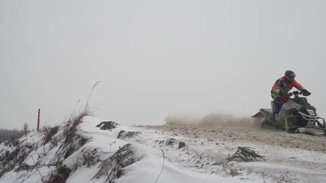 Russia, Championship on snowmobiles January 27, 2018: Winter racing on snowmobiles. Snowmobile on the route in a jump. Action from snowmobile races.