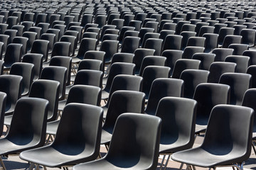 Rows of empty black plastic seats