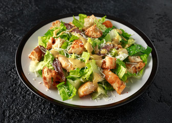 Caesar salad with chicken, anchous fish, croutons, parmesan cheese and greens. healthy food