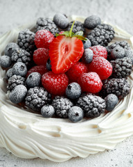 Berry Pavlova cake with fresh blueberries, strawberries and raspberries