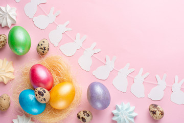 Easter eggs colored with rabbit ears and sweets .flat lay with space for design
