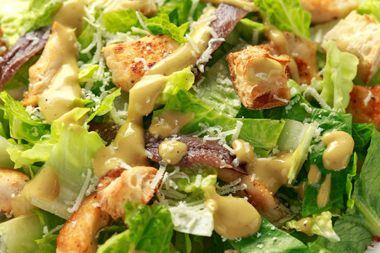 Caesar salad with chicken, anchous fish, croutons, parmesan cheese and greens. healthy food