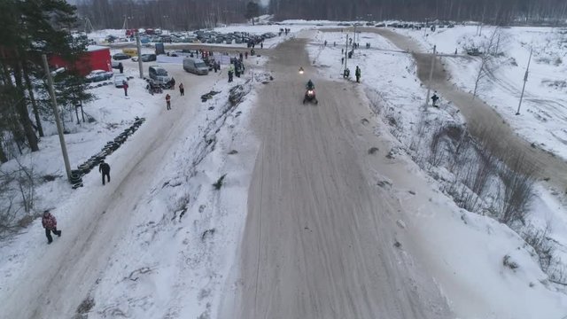Russia, Championship on snowmobiles January 27, 2018: Winter racing on snowmobiles. Aerial view: Snowmobile on the route in a jump. Action from snowmobile races.