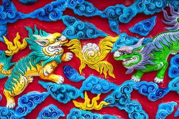 Chinese style dragon sculptures on the temple walls.Bangkok.Thailand.