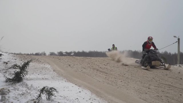 Russia, Championship on snowmobiles January 27, 2018: Winter racing on snowmobiles. Snowmobile on the route in a jump. Action from snowmobile races.