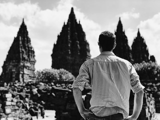 Tourist man enjoying the view of Prambanan temple in Yogyakarta.